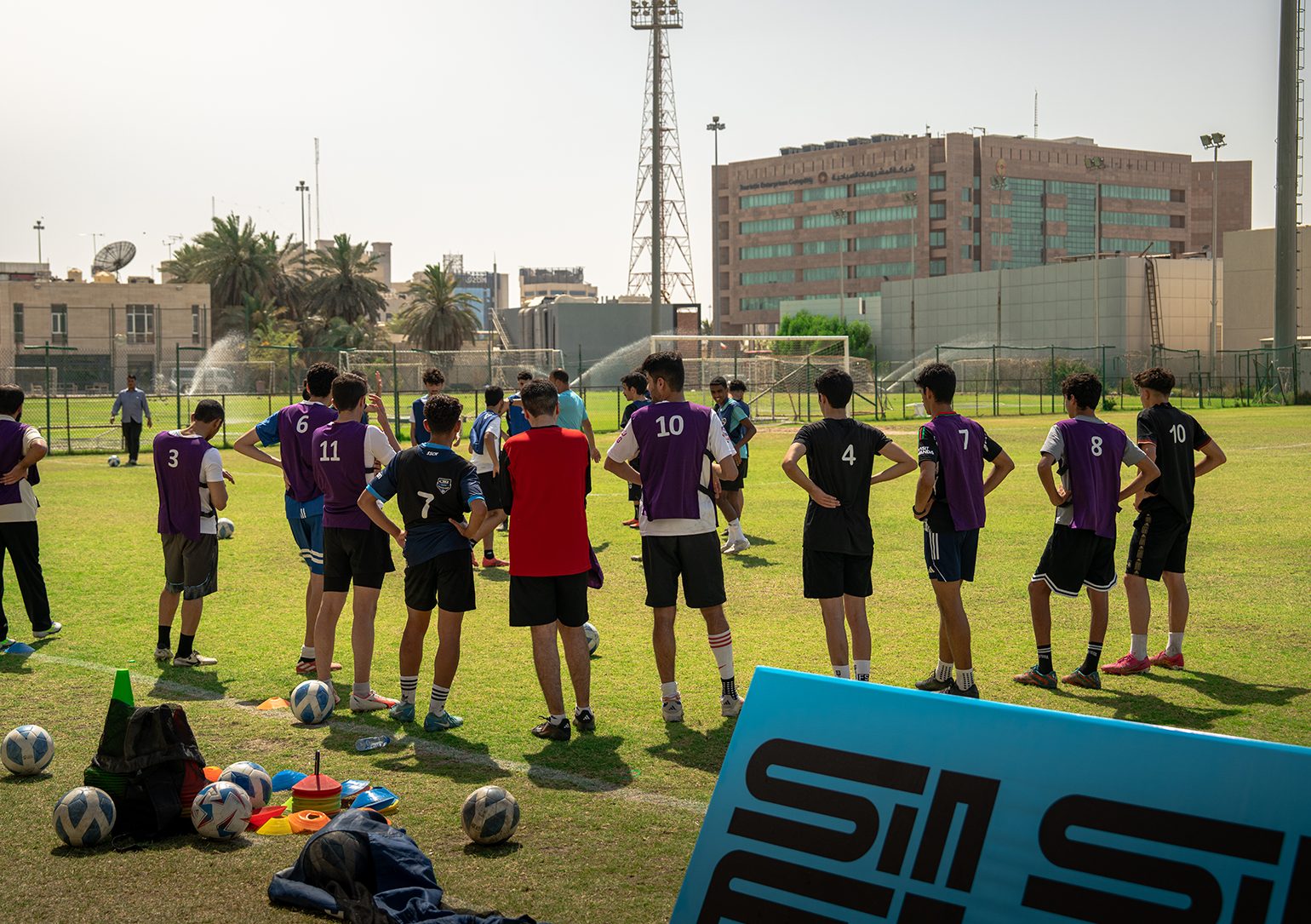 Young footballers gathered on a pitch in Kuwait at the SinFin x TFA scouting trial.